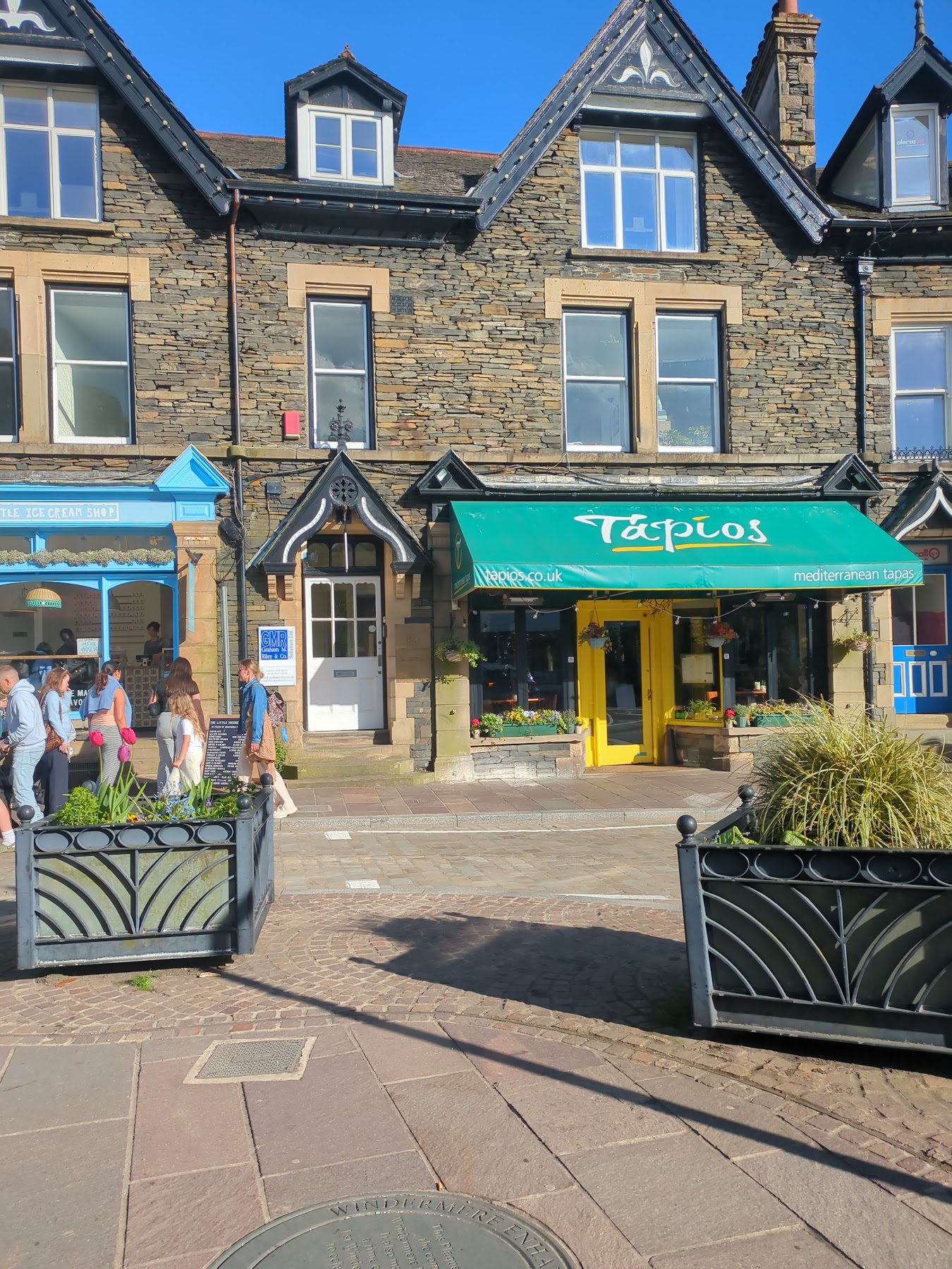 The green and yellow Tapios storefront in Windermere