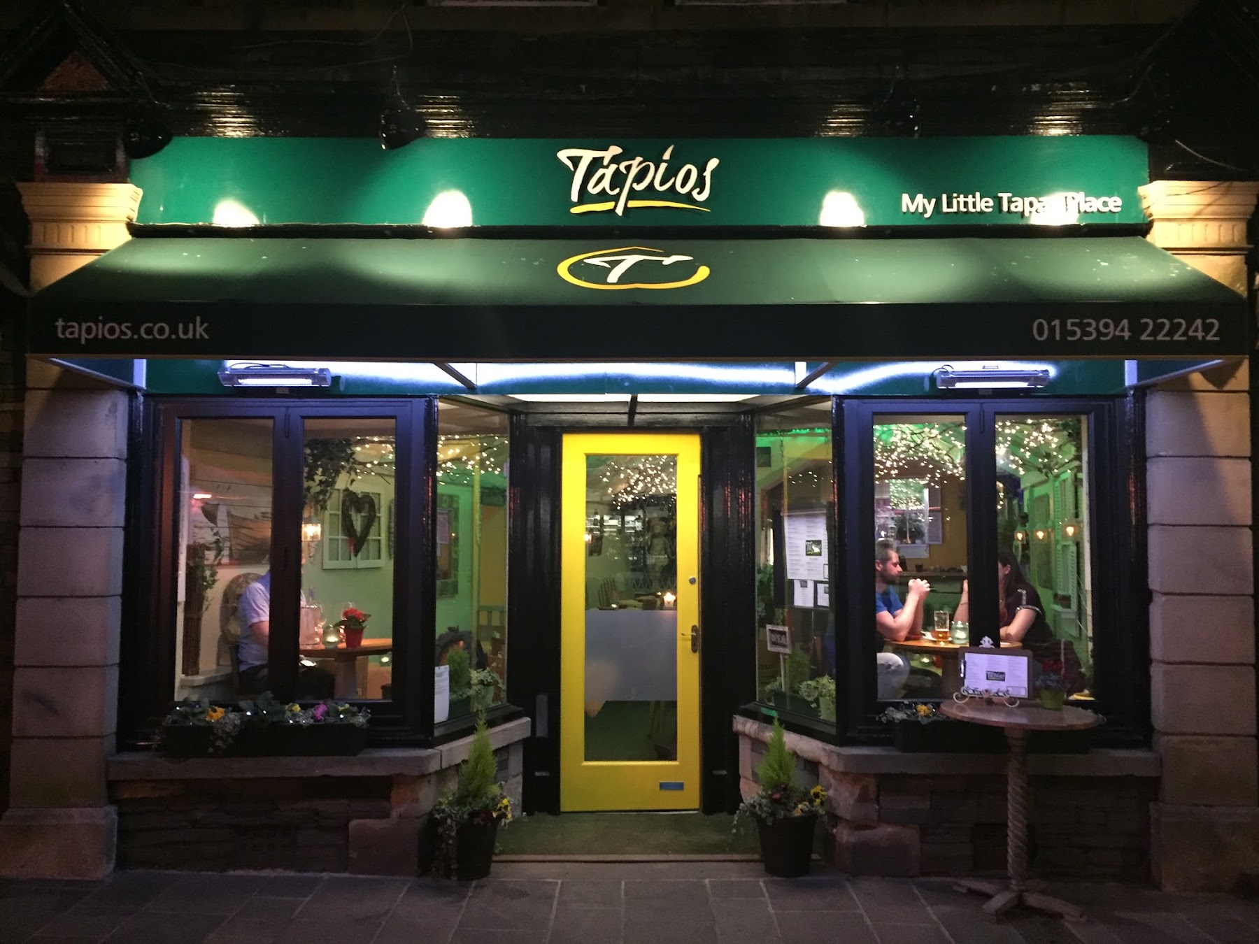 Tapios restaurant glowing at night on Crescent Road